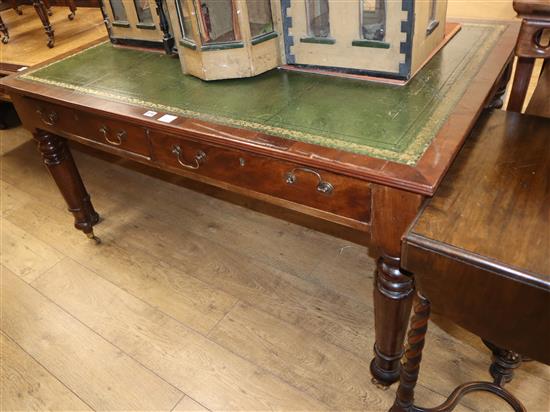 A Victorian mahogany partners writing table, with green gilt tooled leather inset top W.150cm